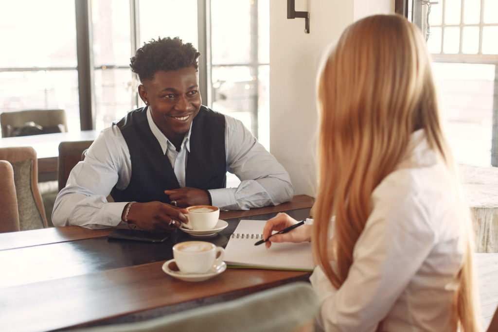 man and woman having an interview at coffee shop