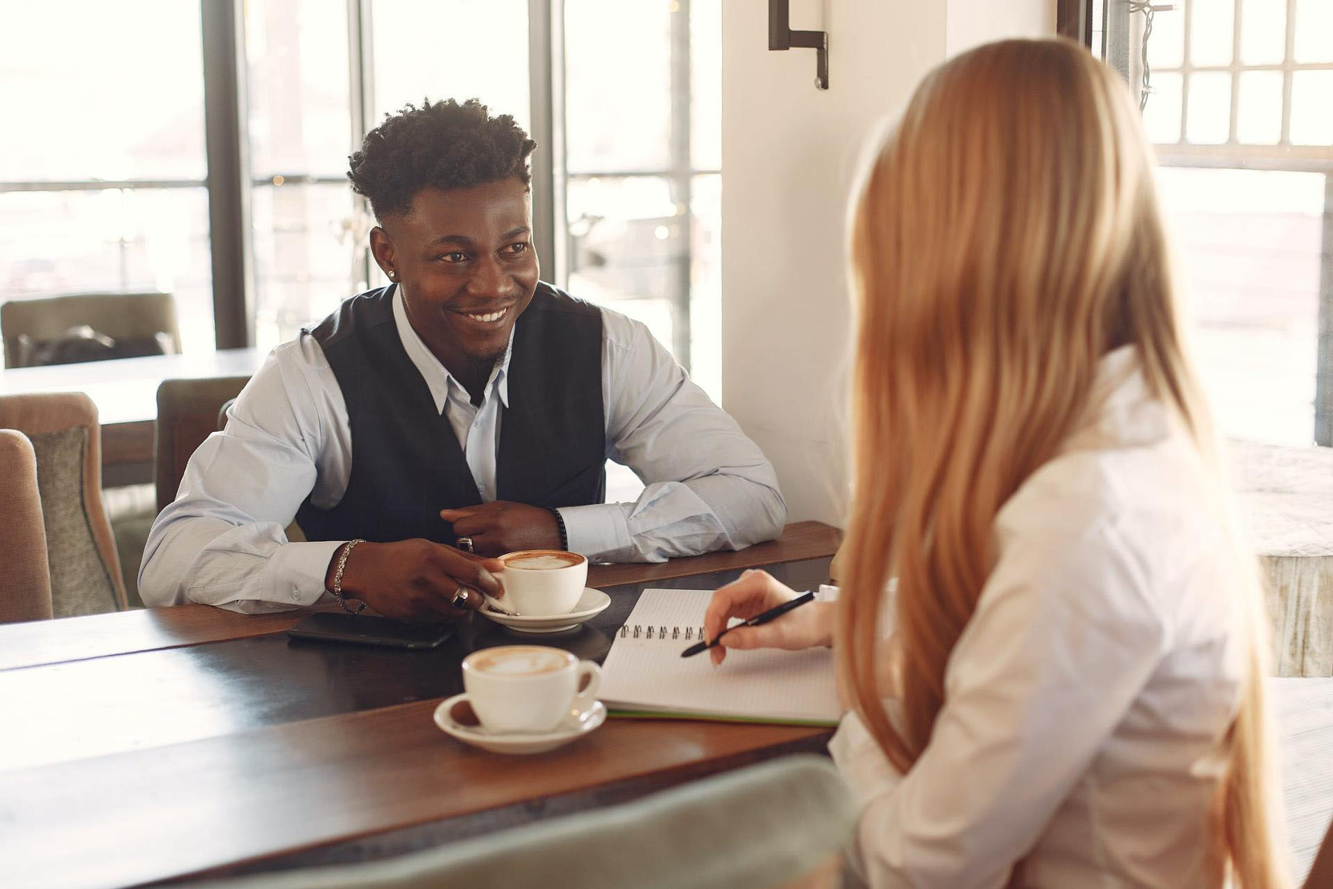 man and woman having an interview at coffee shop